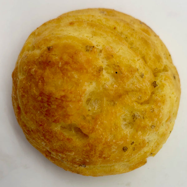 Close-up on a bite of Cheddar gougères